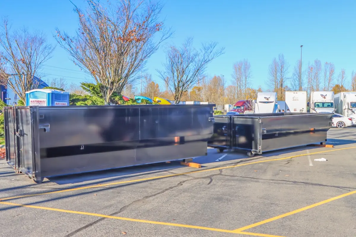 Professional dumpster rental service with roll-off container on residential driveway in Eunice